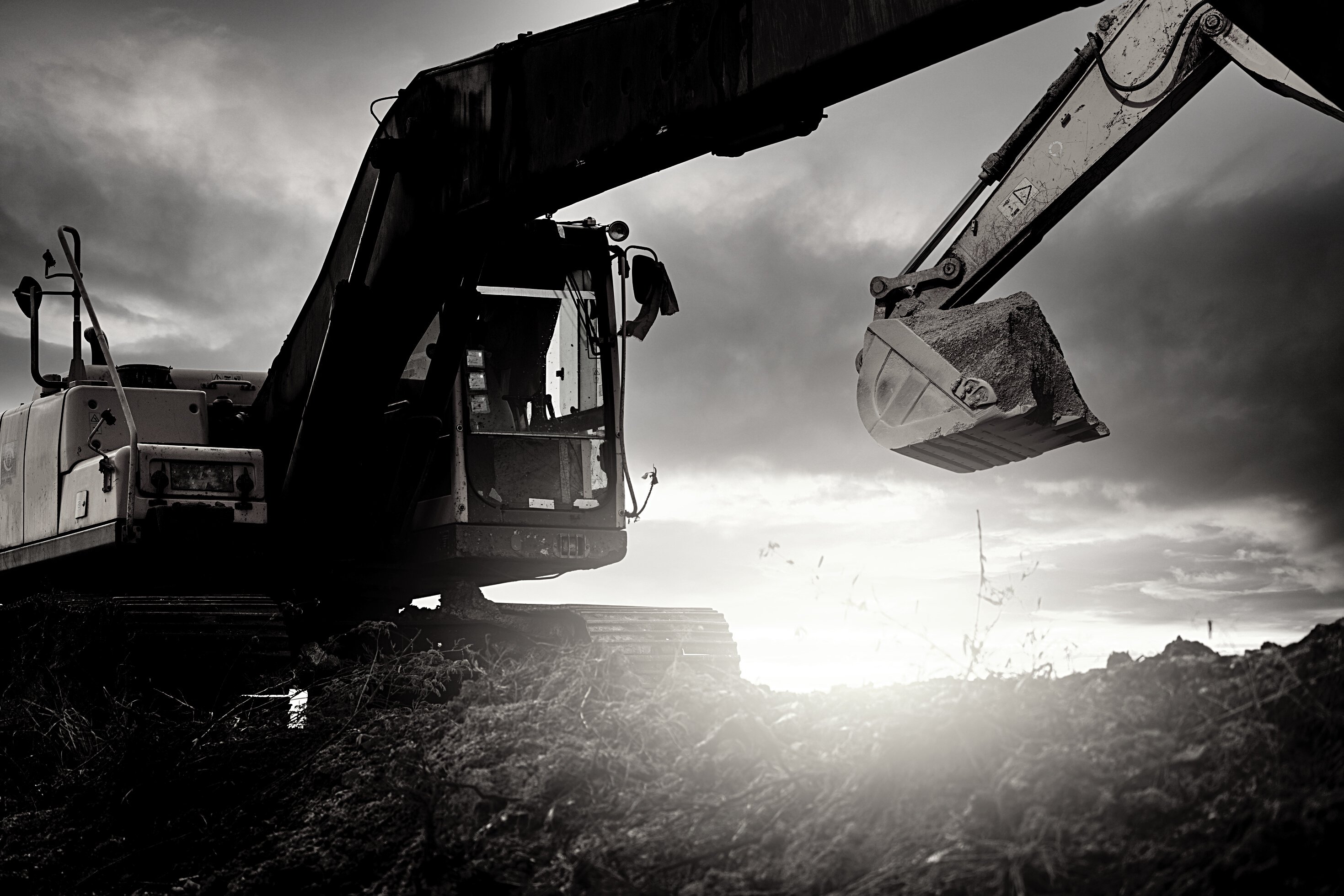 Backhoe at Construction Site Digging Soil with Bucket of Backhoe